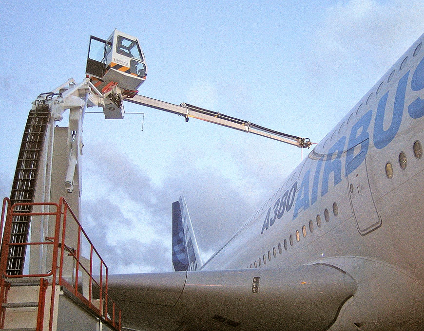 Airbus A380 being serviced with a maintenance lift and platform for access to the aircraft's upper sections.