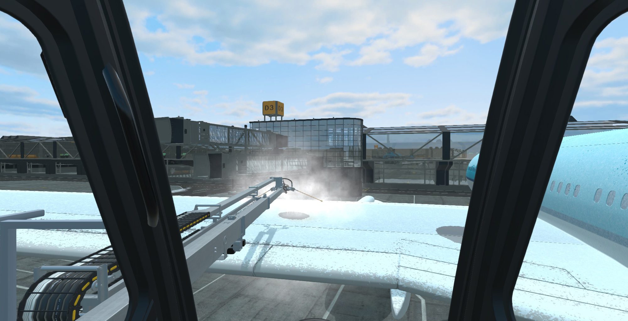 View from an aircraft cockpit showing a de-icing process on the wing, with airport buildings in the background.