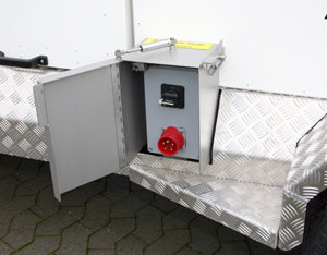 Electrical connection box with a red outlet and a digital display, mounted on a metallic surface with a hinged door.